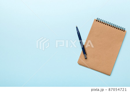 school brown notebook on a colored background, spiral craft notepad on a table Top view school brown notebook on a colored background, spiral craft notepad on a table Top view 87054721