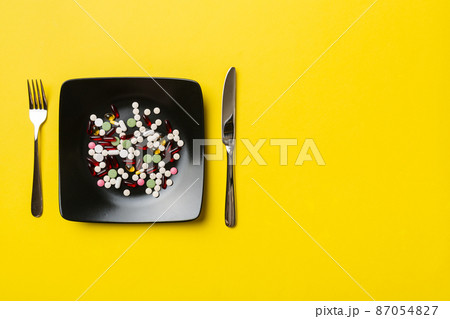 Many different weight loss pills and supplements as food on round plate. Pills served as a healthy meal. Drugs, pharmacy, medicine or medical healthycare concept Many different weight loss pills and supplements as food on round plate. Pills served as a healthy meal. Drugs, pharmacy, medicine or medical healthycare concept 87054827