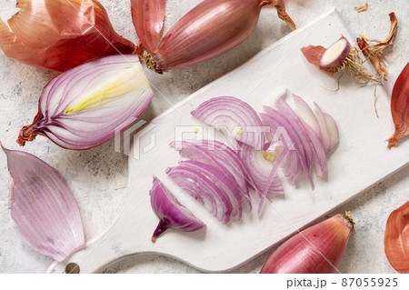 Sliced Red tropea onions on a white board top view 87055925