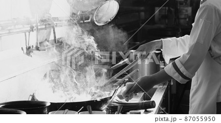 Chef stir fry busy cooking in kitchen Chef stir fry busy cooking in kitchen 87055950