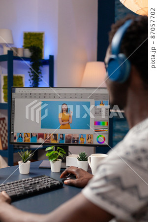 African american artist photographer with headset retouching designer pictures 87057702