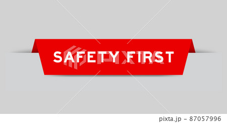 Red color inserted label with word safety first on gray background 87057996