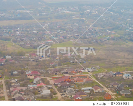 View of the countryside from the height of the plane landing. Soft focus View of the countryside from the height of the plane landing. Soft focus 87058982