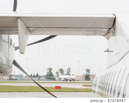 Fragment of the wing of a white mini plane standing at the airport 87058987