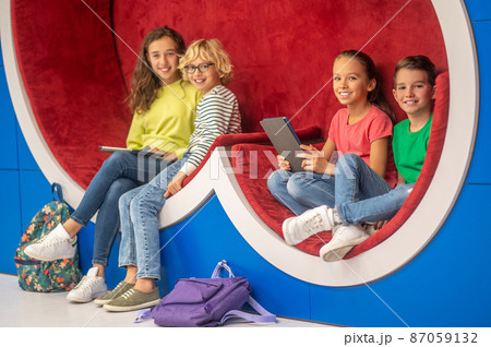 Classmates sitting resting looking at camera 87059132