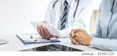 Professor Doctor consulting with patient discussing something and recommend treatment methods, Presenting results on report and x-ray film, Medicine and health care concept 87061129