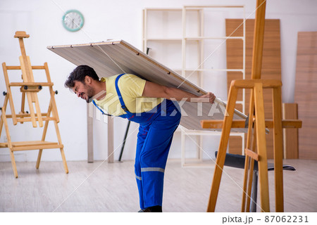 Young male carpenter working at home 87062231