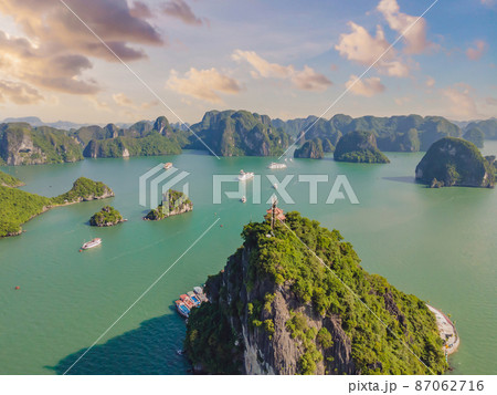 Aerial view panorama of floating fishing village and rock island, Halong Bay, Vietnam, Southeast Asia. UNESCO World Heritage Site. Junk boat cruise to Ha Long Bay. Popular landmark of Vietnam Aerial view panorama of floating fishing village and rock island, Halong Bay, Vietnam, Southeast Asia. UNESCO World Heritage Site. Junk boat cruise to Ha Long Bay. Popular landmark of Vietnam 87062716