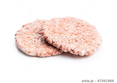 Frozen hamburger meat. Raw beef patties isolated on white background. Frozen hamburger meat. Raw beef patties isolated on white background. 87062866