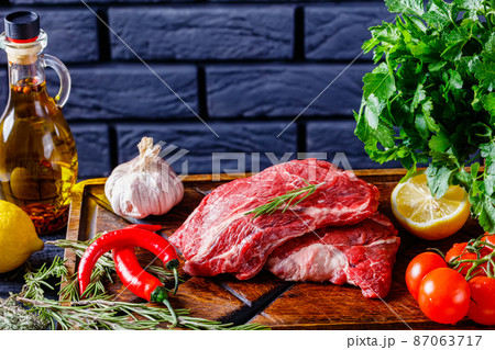chuck eye beef steaks on wooden board 87063717