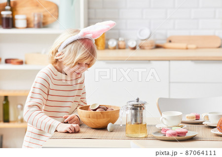 Little Boy on Easter Egg Hunt Indoors 87064111