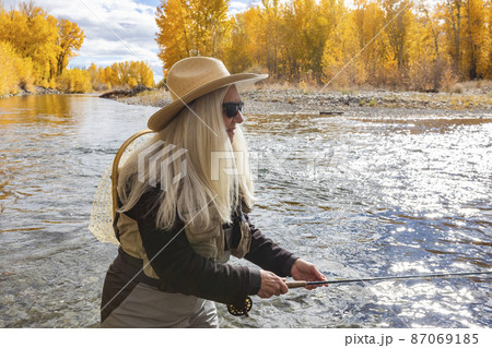 USA, Idaho, Bellevue, Senior woman fly-fishing in Big Wood River in autumn USA, Idaho, Bellevue, Senior woman fly-fishing in Big Wood River in autumn 87069185
