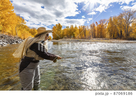 USA, Idaho, Bellevue, Senior woman fly-fishing in Big Wood River in autumn 87069186