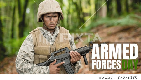 Digital composite image of text over biracial young male soldier standing with rifle Digital composite image of text over biracial young male soldier standing with rifle 87073180