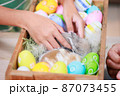 Asian child girl touching tiny bunny with tenderness and love. Baby rabbits in the nest with mommy fur and hay. People take care a pet and decorate home for Easter. Happy Easter Happy holiday. 87073455
