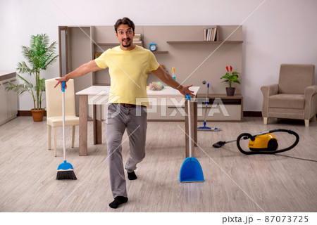 Young man doing housework at home 87073725