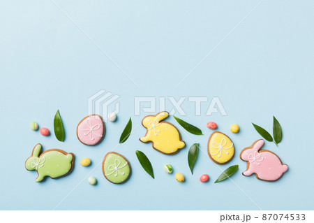 holiday preparation Multi colors Easter eggs with cookies on colored background . Pastel color Easter eggs. holiday concept with copy space holiday preparation Multi colors Easter eggs with cookies on colored background . Pastel color Easter eggs. holiday concept with copy space 87074533
