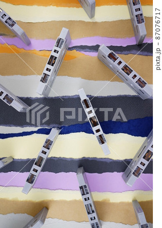 Cassette tapes, classic vintage antique nostalgia flat lay on torn colored paper background. Cassette tapes, classic vintage antique nostalgia flat lay on torn colored paper background. 87076717