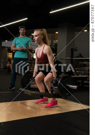 Instructor led training helps a beautiful client to perform exercises in a fitness club, the concept of playing sports with a professional gym leisure lifestyle male modern, for personal senior for Instructor led training helps a beautiful client to perform exercises in a fitness club, the concept of playing sports with a professional gym leisure lifestyle male modern, for personal senior for 87077387