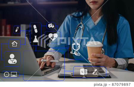 Medical students use mobile phones to search for information in a modern office in the morning at the desk. Medical students use mobile phones to search for information in a modern office in the morning at the desk. 87079897