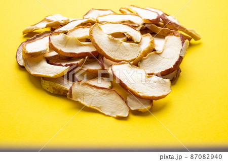 Dried apple on a yellow background close-up. Dried apple on a yellow background close-up. 87082940