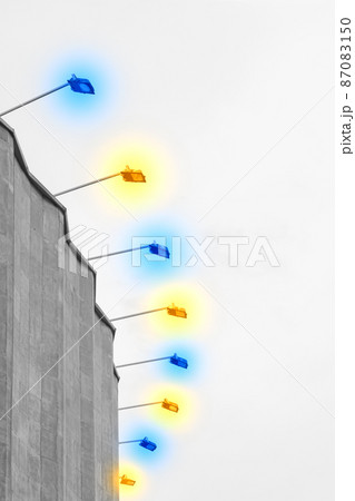 Concrete old building architecture structure cement facade apartment stone with elements of illumination bulbs on the roof against a background of gray sky 87083150