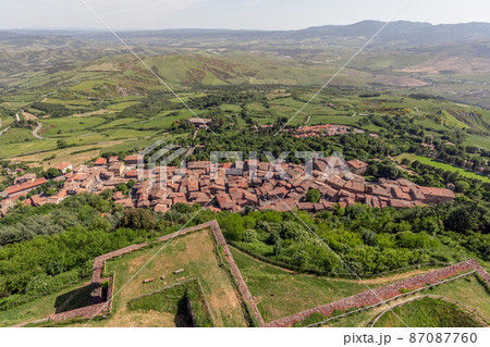 Narrow streets of old little Radicofani village with tiled roofs and church. Val d'Orcia. Tuscany Narrow streets of old little Radicofani village with tiled roofs and church. Val d'Orcia. Tuscany 87087760