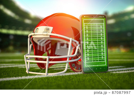 American football app video game on smartphone and betting sport online concept. Mobile phone and american football helmet. American football app video game on smartphone and betting sport online concept. Mobile phone and american football helmet. 87087997