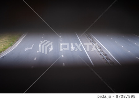 forward and left arrow on the track. White arrow sign painted on black asphalt. Transport background. Three-lane modern asphalt road forward and left arrow on the track. White arrow sign painted on black asphalt. Transport background. Three-lane modern asphalt road 87087999