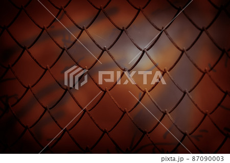 Scary horror abstract red orange dark background. Grid with mystical paranormal fantastic bloody moonlight in the night and twilight mysterious otherworldly shadows. The concept of parallel worlds 87090003