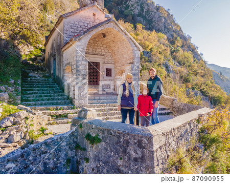 Family of hikers on Hiking in Kotor Old Town Ladder of Kotor Fortress Hiking Trail. Aerial drone view 87090955
