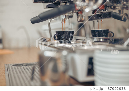 Professional coffee machine brewing espresso in cafe 87092038