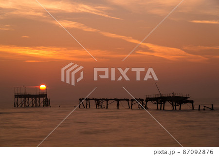 Beautiful sunrise over the old broken bridge. Low lihgt long exposure. Copy space. Beautiful sunrise over the old broken bridge. Low lihgt long exposure. Copy space. 87092876