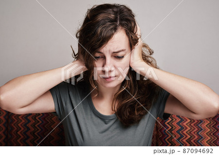 Woman covered her ears with hands, strong head pain Woman covered her ears with hands, strong head pain 87094692