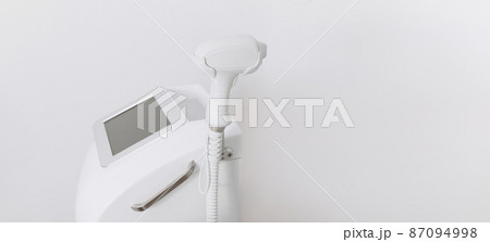 A laser hair removal machine with working part of the epilator in a modern beauty salon on white background. Underarm Laser Hair Removal concept 87094998