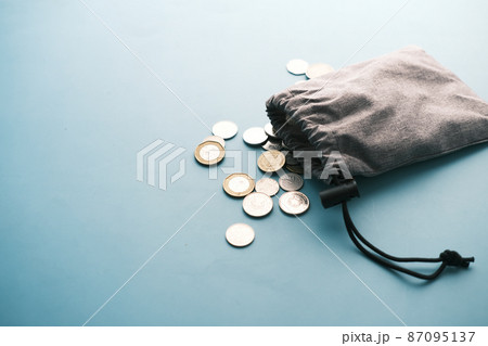 top view of coins spilling from a small bag  87095137
