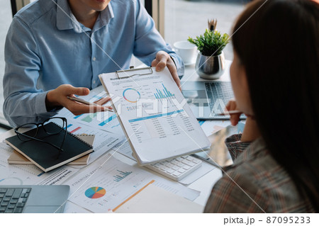 Business team meeting present, investor colleagues discussing new plan financial graph data on office table with laptop and digital tablet, Finance, accounting, investment. Business team meeting present, investor colleagues discussing new plan financial graph data on office table with laptop and digital tablet, Finance, accounting, investment. 87095233
