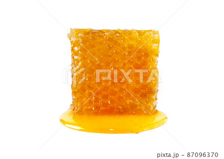 Sweet honey and honeycomb. Healthy organic honey and slice of honeycomb isolated on white background. Sweet healthy dessert. 87096370