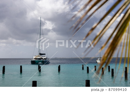Sailboat on azure sea in stormy weather. Selective focus. Sailboat on azure sea in stormy weather. Selective focus. 87099410