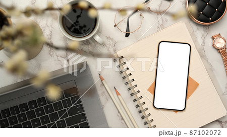 Modern female office desk with smartphone mockup in marble white background. 87102072