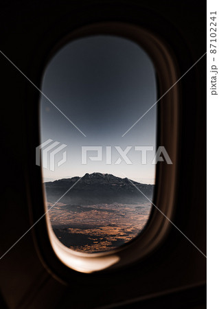 View of the mountain through the window of the plane. 87102241