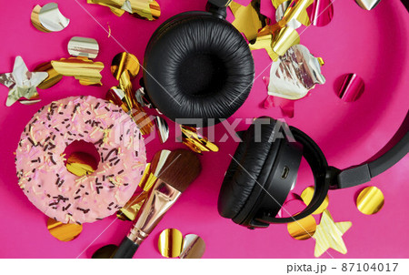 gift box for girls to listen to music on headphones. pink donut, headphones and makeup brush among the sparkles 87104017