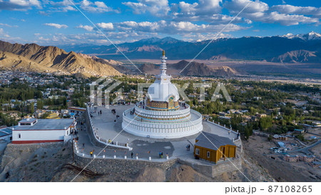 Aerial view Shanti Stupa buddhist white domed stupa overlooks the city of Leh, The stupa is one of the ancient and oldest stupas located in Leh city, Ladakh, Jammu Kashmir, India. Aerial view Shanti Stupa buddhist white domed stupa overlooks the city of Leh, The stupa is one of the ancient and oldest stupas located in Leh city, Ladakh, Jammu Kashmir, India. 87108265