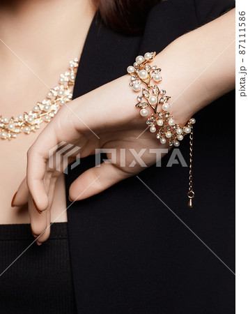woman with elegant golden bracelet 87111586