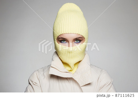 beautiful girl in yellow balaclava. Trendy Mask on pretty woman 87111625