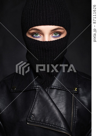 beautiful girl in black balaclava and leather coat. Trendy Mask beautiful girl in black balaclava and leather coat. Trendy Mask 87111626