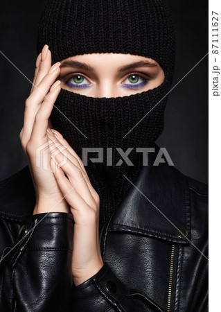 beautiful girl in black balaclava and leather coat 87111627