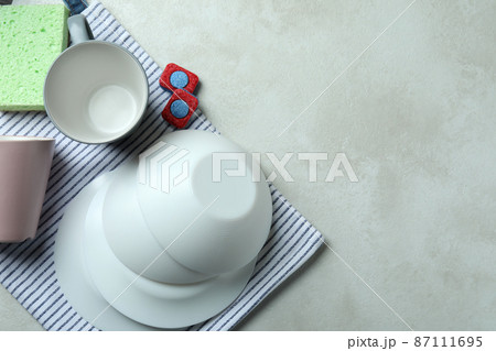 Concept of Dishwashing detergent accessories on white textured table 87111695