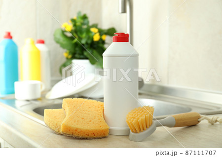 Concept of Dishwashing detergent accessories on kitchen background 87111707
