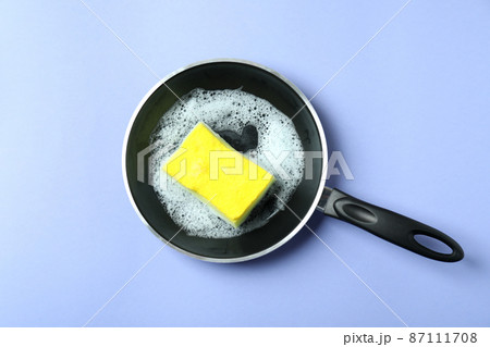 Concept of Dishwashing accessories on violet background Concept of Dishwashing accessories on violet background 87111708